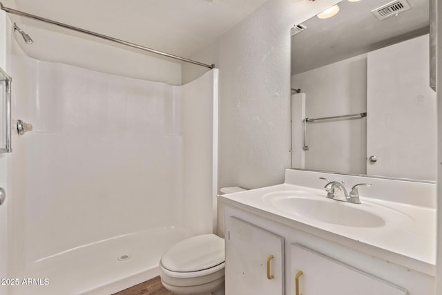 12221 W Bell Rd Unit 249, Surprise, AZ 85378 - full bath with a shower, toilet, vanity, a textured wall, and wood finished floors
