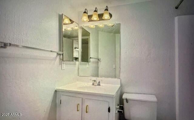 12221 W Bell Rd Unit 249, Surprise, AZ 85378 - bathroom featuring a textured wall, vanity, and toilet