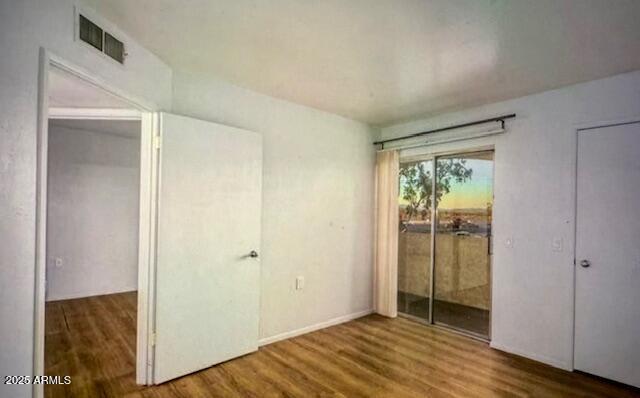 12221 W Bell Rd Unit 249, Surprise, AZ 85378 - unfurnished bedroom with wood finished floors and access to outside