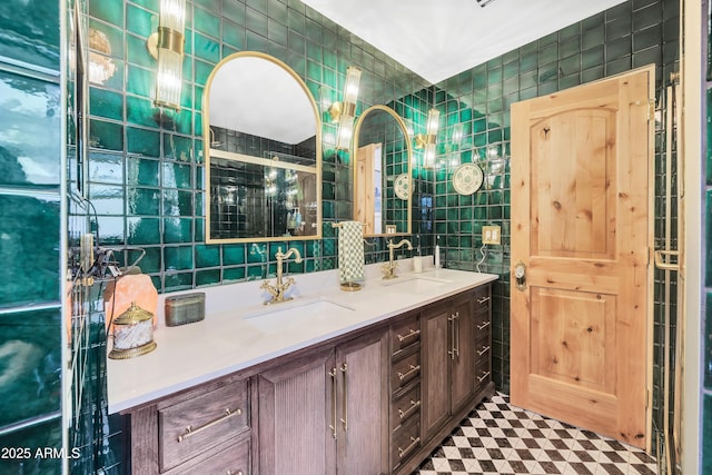 bathroom featuring vanity and tile walls