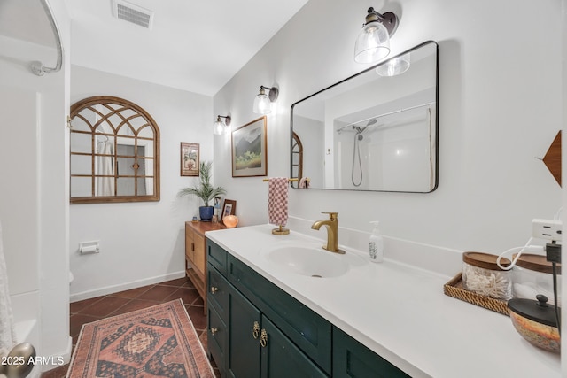 bathroom featuring vanity, tile patterned floors, and walk in shower