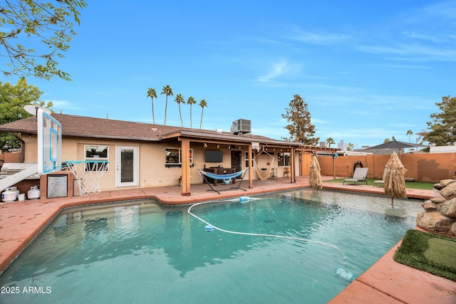 view of swimming pool with a patio and cooling unit