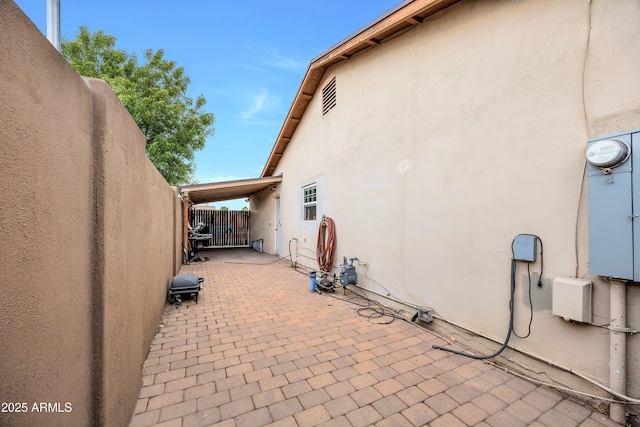 view of side of property featuring a patio area