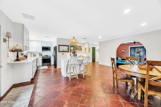 tiled dining room with ceiling fan