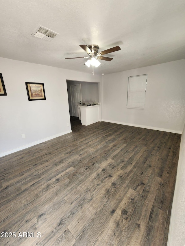 spare room with ceiling fan and dark wood-type flooring