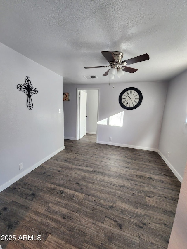 unfurnished room featuring ceiling fan, a textured ceiling, and dark hardwood / wood-style floors