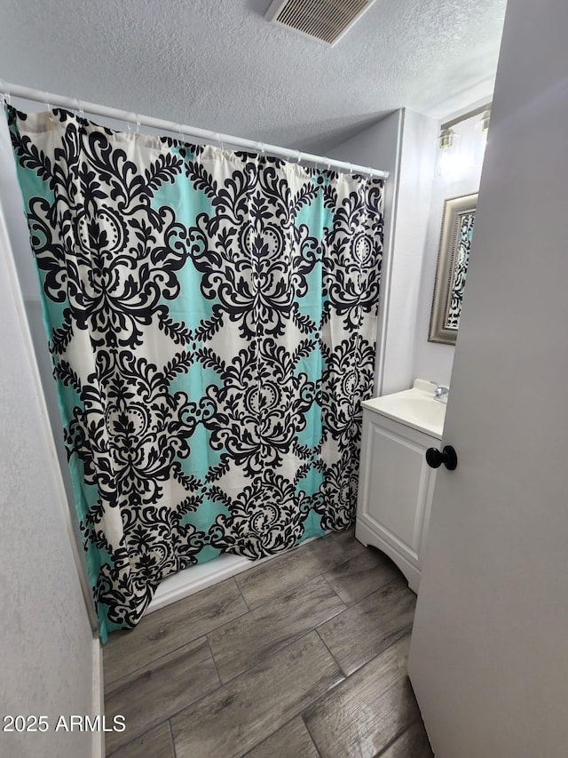 bathroom with vanity and a textured ceiling