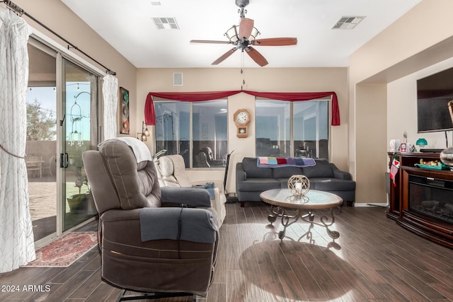 living room with dark hardwood / wood-style flooring and ceiling fan