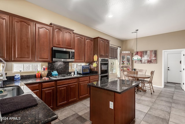 kitchen featuring a center island, light tile patterned floors, tasteful backsplash, decorative light fixtures, and stainless steel appliances