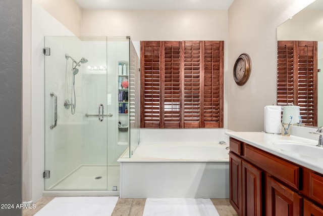 bathroom featuring tile patterned floors, vanity, and separate shower and tub