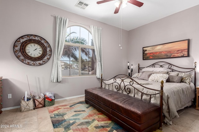 tiled bedroom featuring ceiling fan