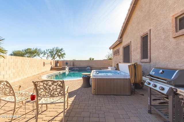 view of pool featuring a grill, pool water feature, a patio area, and a hot tub