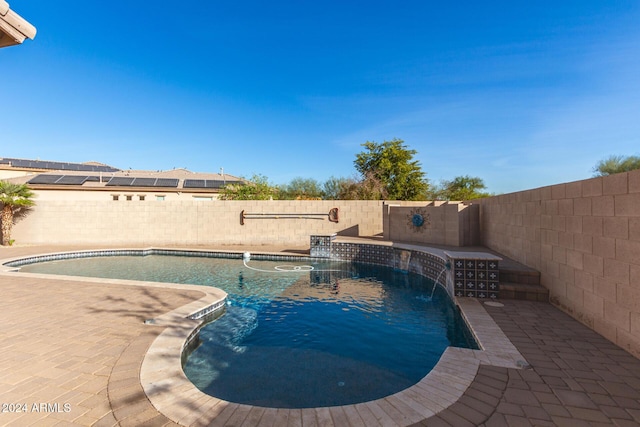 view of swimming pool with pool water feature