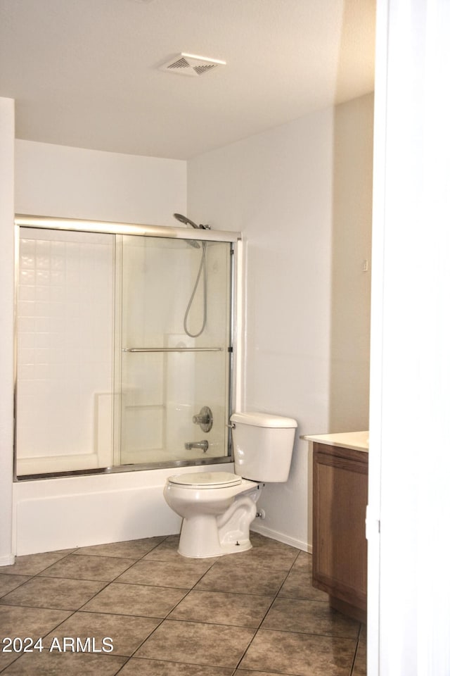9527 N 82nd Ln, Peoria, AZ 85345 - full bathroom featuring tile patterned floors, vanity, toilet, and shower / bath combination with glass door
