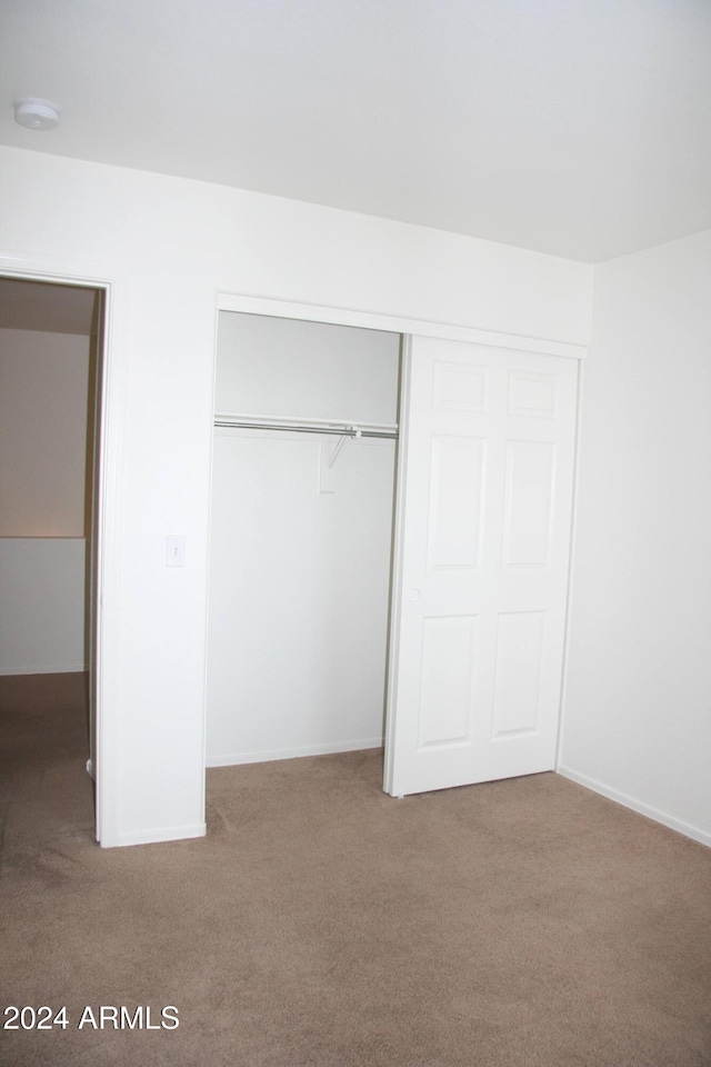 9527 N 82nd Ln, Peoria, AZ 85345 - unfurnished bedroom featuring a closet and carpet floors