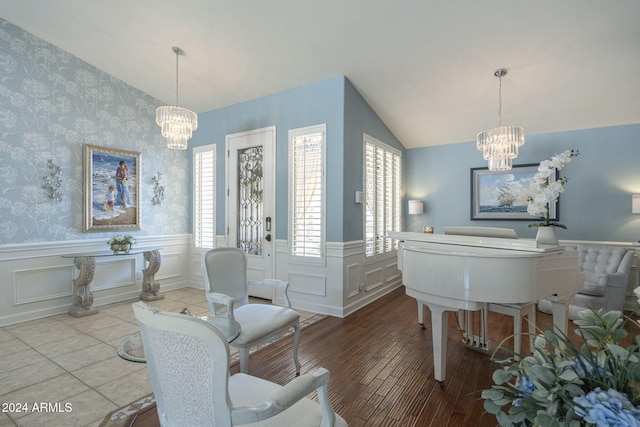 interior space with lofted ceiling, hardwood / wood-style floors, and a chandelier