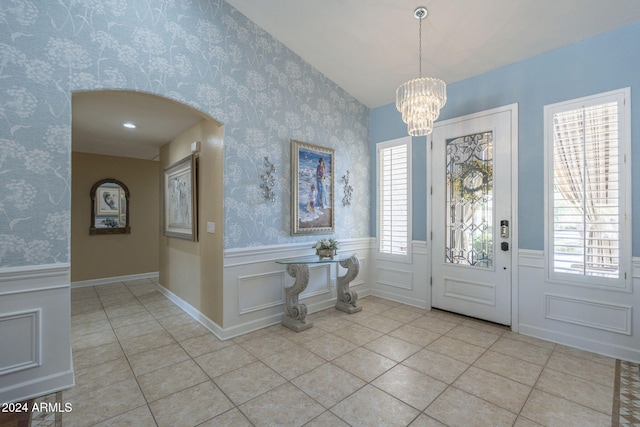 entrance foyer with a notable chandelier and light tile patterned floors