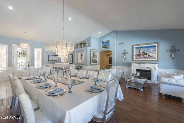 dining room with dark hardwood / wood-style flooring and vaulted ceiling