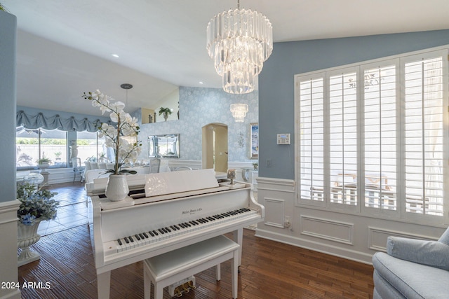 misc room with a notable chandelier, vaulted ceiling, and dark hardwood / wood-style floors