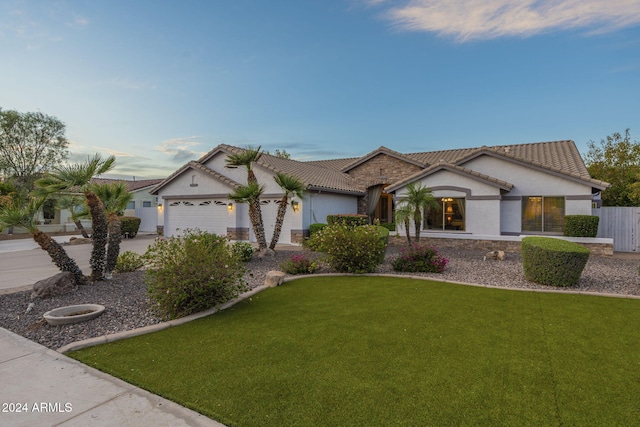 view of front of home featuring a front yard and a garage