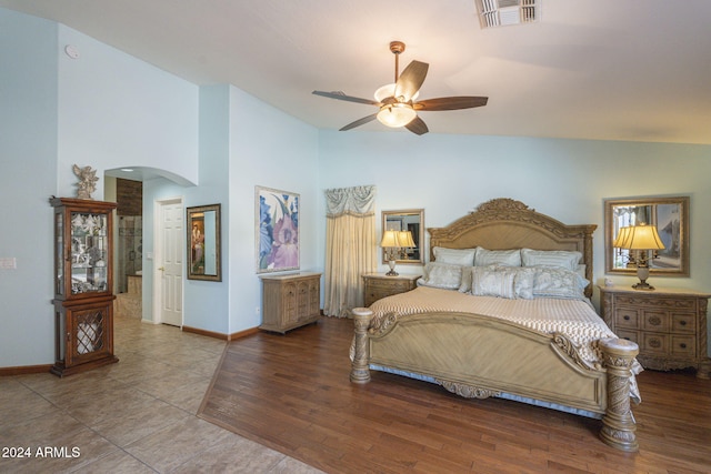 bedroom with ceiling fan, hardwood / wood-style flooring, and high vaulted ceiling