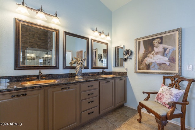 bathroom featuring vanity, tile patterned floors, and lofted ceiling