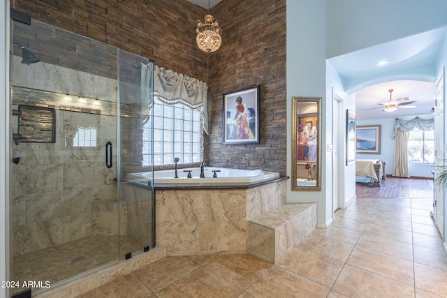 bathroom with ceiling fan, high vaulted ceiling, tile patterned flooring, and plus walk in shower