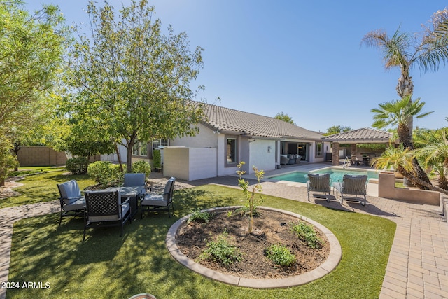 exterior space with a yard, a patio area, and a fenced in pool