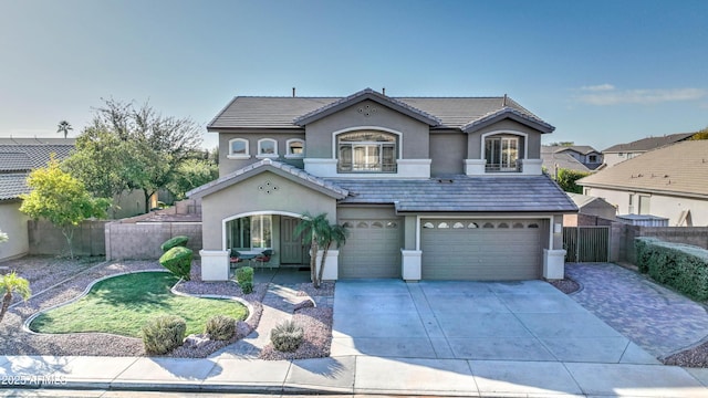 view of property featuring a garage and a balcony