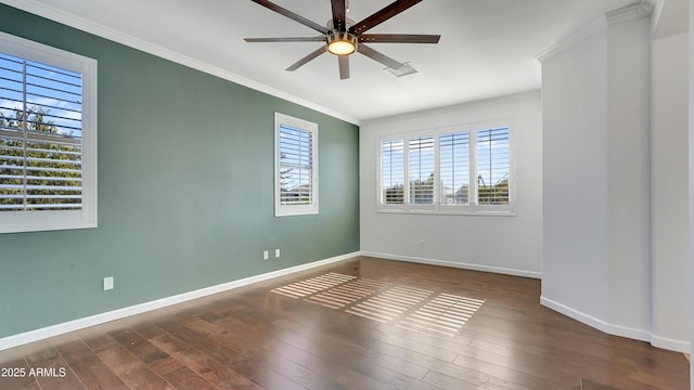 spare room with crown molding, dark wood-type flooring, and ceiling fan