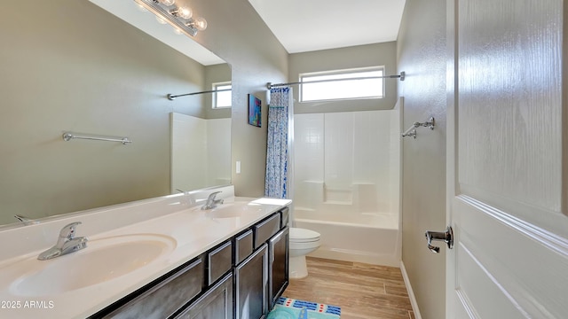 full bathroom with vanity, hardwood / wood-style floors, shower / tub combo, and toilet