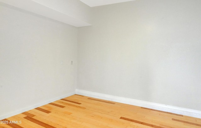 unfurnished room with hardwood / wood-style floors