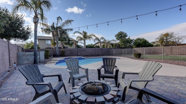 view of pool featuring a patio and a fire pit