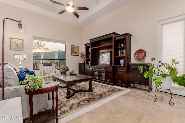 interior space with ceiling fan and a towering ceiling