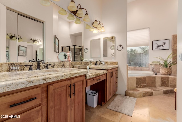 bathroom featuring tiled bath and vanity