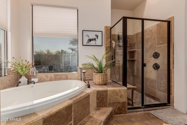 bathroom with shower with separate bathtub