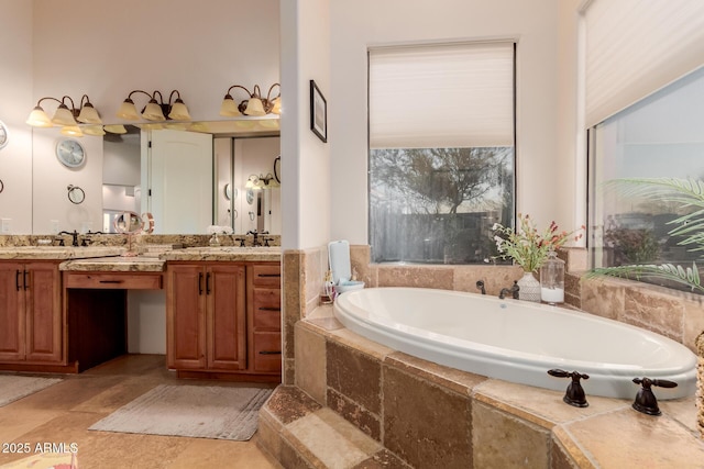 bathroom with vanity and a relaxing tiled tub