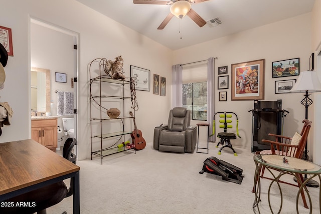 living area featuring ceiling fan and carpet