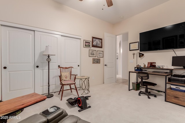 carpeted home office with ceiling fan