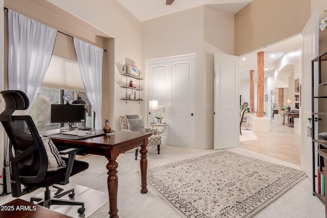 home office featuring a towering ceiling