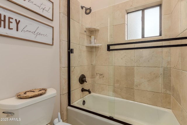 bathroom featuring toilet and combined bath / shower with glass door