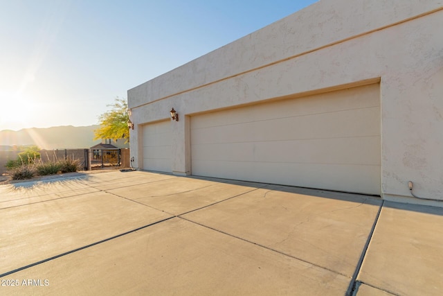 view of garage at dusk