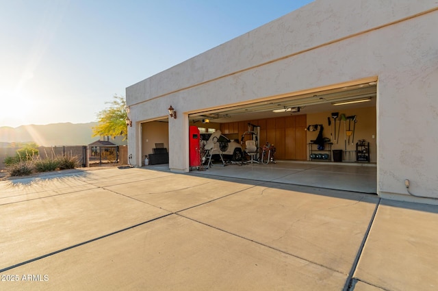 garage at dusk featuring a garage door opener