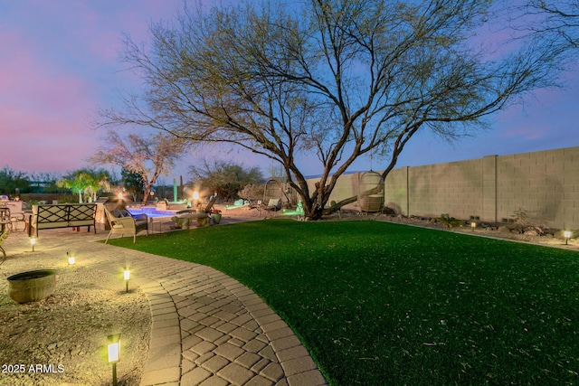 yard at dusk with a patio area