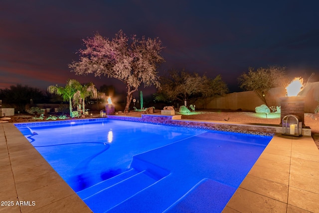 view of swimming pool featuring an outdoor fireplace