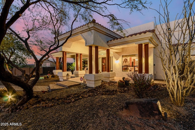 back house at dusk with a patio