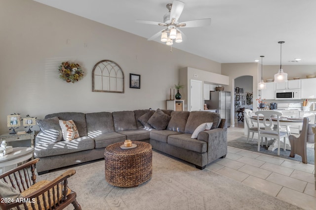 living room with ceiling fan and light tile patterned flooring