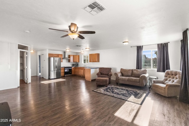 living room with ceiling fan, sink, and dark wood-type flooring