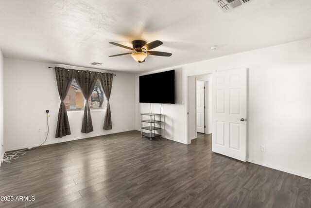 spare room featuring ceiling fan and dark wood-type flooring