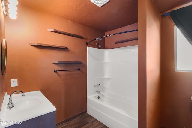 bathroom featuring shower / bath combination, vanity, and wood-type flooring